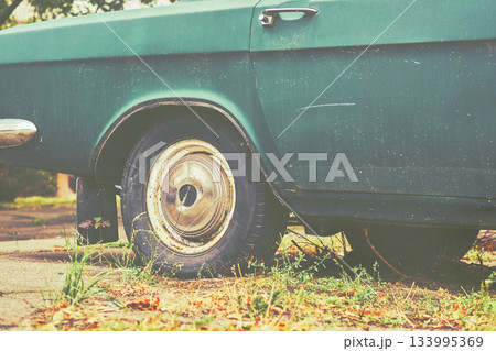 Old retro photo of vintage car,rear wheel 133995369