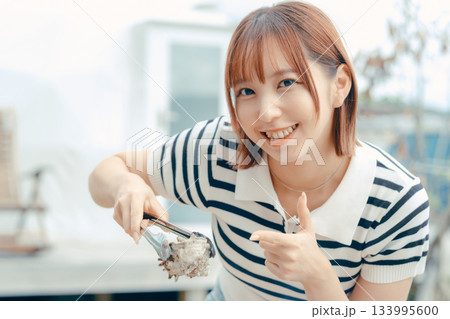 海辺で海鮮を焼く20代女性 133995600