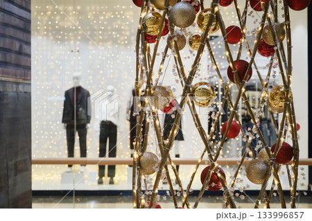 Christmas decorations with blurred storefront mannequins shopping concept Christmas decorations with blurred storefront mannequins shopping concept 133996857