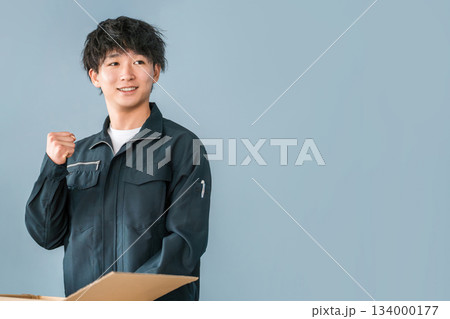 ダンボールに箱詰めする運送・物流・宅急便・宅配便・流通・配達・宅配業者の作業員の男女 134000177