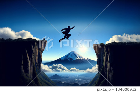 富士山と青空を背景に崖を飛び越えるビジネスマンの挑戦イメージ 134000912