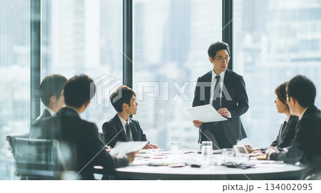 会議室で資料を確認するビジネスチームの打ち合わせ 134002095