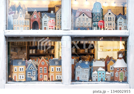 Small houses figurines in a window Small houses figurines in a window 134002955