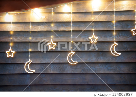 Bright glowing Xmas decoration. Stars and moon Bright glowing Xmas decoration. Stars and moon 134002957