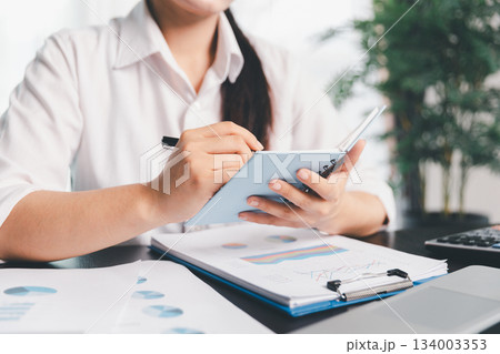 Business woman analyze calculate company financial, tax results office accounting statistics analytical research. calculating business balance prepare tax reduction. Tax deduction planning concept. Business woman analyze calculate company financial, tax results office accounting statistics analytical research. calculating business balance prepare tax reduction. Tax deduction planning concept. 134003353