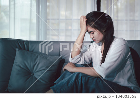 Sorrowful woman sat alone, overwhelmed by emotion, her sad and unhappy expression revealing deep despair, stress and distress left feeling depressed. sorrowful sad, despair alone, depressed stress Sorrowful woman sat alone, overwhelmed by emotion, her sad and unhappy expression revealing deep despair, stress and distress left feeling depressed. sorrowful sad, despair alone, depressed stress 134003358