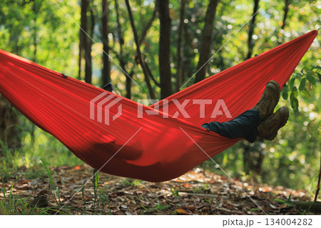 Relaxing in hammock in tropical forest Relaxing in hammock in tropical forest 134004282