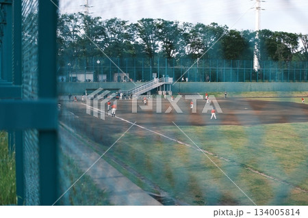 フェンス越しの野球場と練習試合 フェンス越しの野球場と練習試合 134005814