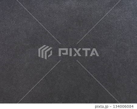 Subtle interplay of black and gray granules on a textured paper surface Subtle interplay of black and gray granules on a textured paper surface 134006084