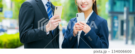 スマホを使うビジネスマンとビジネスウーマン 134006600