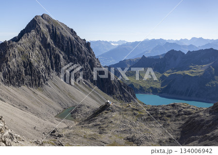 Hike to Schesaplana with view of Lunersee lake and Totalp-Hutte in Ratikon mountain range, Vorarlberg, Austria Hike to Schesaplana with view of Lunersee lake and Totalp-Hutte in Ratikon mountain range, Vorarlberg, Austria 134006942