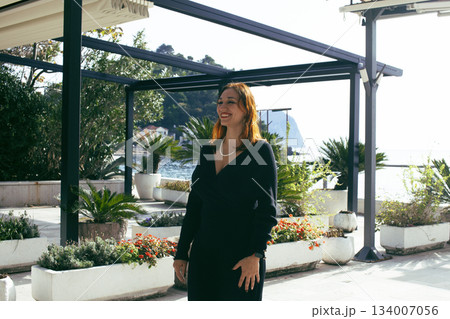 pretty young woman on stylish promenade at seaside, lifestyle people concept 134007056