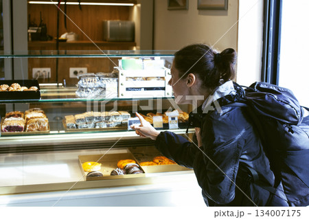 two girl friends having fun with street food in europe, lifestyle people concept 134007175