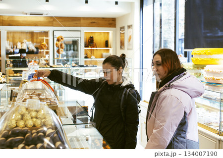 two girl friends having fun with street food in europe, lifestyle people concept two girl friends having fun with street food in europe, lifestyle people concept 134007190