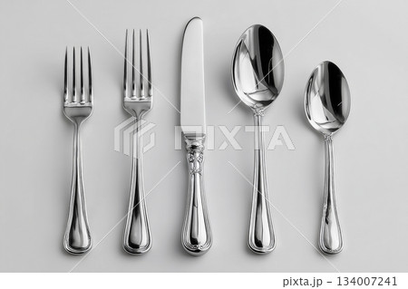 Luxury home decor. Full silverware set. Including soup spoon, dinner fork, knife, dessert fork and teaspoon, perfectly arranged on a white background. Formal dining settings Luxury home decor. Full silverware set. Including soup spoon, dinner fork, knife, dessert fork and teaspoon, perfectly arranged on a white background. Formal dining settings 134007241