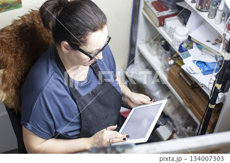 mature woman painter in studio doing online education lesson, lifestyle people concept mature woman painter in studio doing online education lesson, lifestyle people concept 134007303