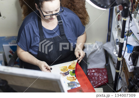 mature woman painter in studio doing online education lesson, lifestyle people concept mature woman painter in studio doing online education lesson, lifestyle people concept 134007309