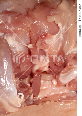 Close up of meat carcass tendons and bones from a chicken that has been carved horror blood red background food waste 134007362
