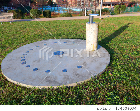 Sundial in park early in morning. Educational and models for astronomy.  134008034