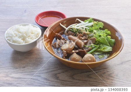 boiled braised beef meat and tendon couple organ in herb brown soup on bowl dipping spicy chili sauce eat couple with plain rice boiled braised beef meat and tendon couple organ in herb brown soup on bowl dipping spicy chili sauce eat couple with plain rice 134008393