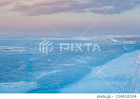 Ice chunks on a frozen lake at scenic sunrise with beautiful light and cold winter background. Ice chunks on a frozen lake at scenic sunrise with beautiful light and cold winter background. 134010104