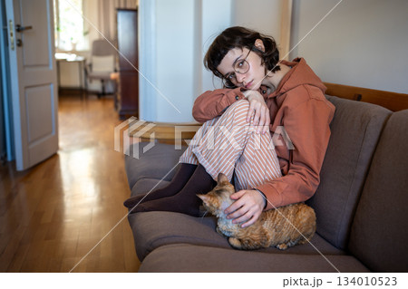 Loving pet owner feeling lonely, stressed stroking cat in need of emotional support, tactile contact 134010523