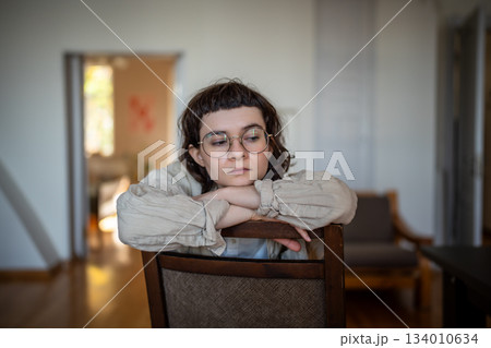 Emotional burnout of young boring woman sitting on chair in sorrow thoughts. Mental problem 134010634