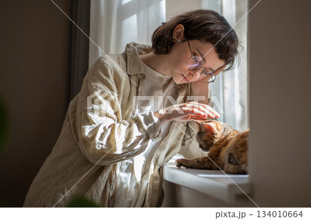 Lonely upset pet owner girl in need of comfort, empathy stroking cat, seeking for emotional support Lonely upset pet owner girl in need of comfort, empathy stroking cat, seeking for emotional support 134010664