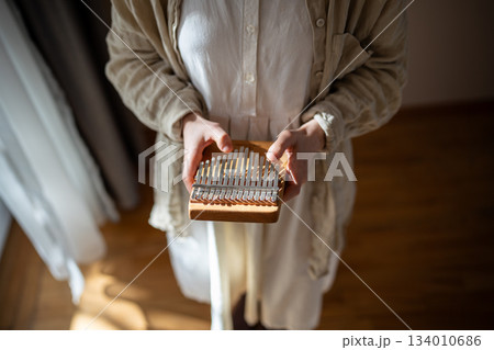 Closeup of woman relaxation metal keys, producing sounds, rhythm, playing ethnic music 134010686