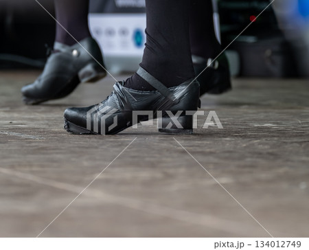 Young Irish Dance Lady in Jig Shoes performing on stage 134012749