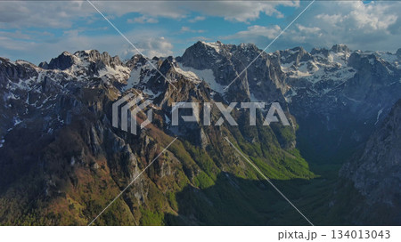 Rocky snow mountains before sunset aerial 134013043