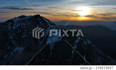 Rocky snow mountains at sunset aerial 134013047