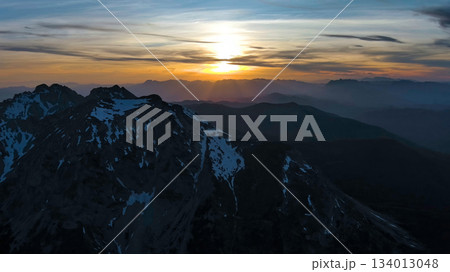 Rocky snow mountains at sunset aerial Rocky snow mountains at sunset aerial 134013048