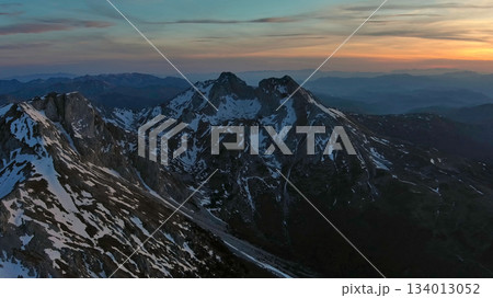 Rocky snow mountains at sunset aerial Rocky snow mountains at sunset aerial 134013052
