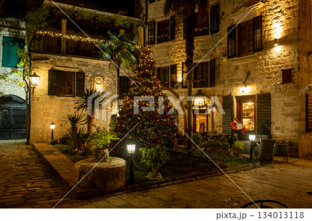 Outdoor Christmas tree decorated with lights in a historic plaza in Kotor Outdoor Christmas tree decorated with lights in a historic plaza in Kotor 134013118