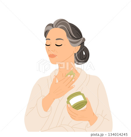 Middle aged East Asian woman with braided gray hair in white bathrobe applying night cream to neck as part of skincare routine. Evening self care for mature skin and graceful aging. Middle aged East Asian woman with braided gray hair in white bathrobe applying night cream to neck as part of skincare routine. Evening self care for mature skin and graceful aging. 134014245