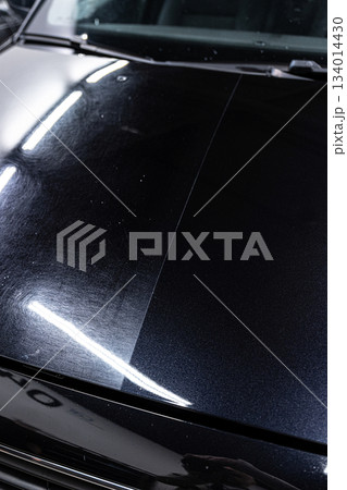 Paint correction before ceramic coating showing 50 50 comparison on car hood 134014430