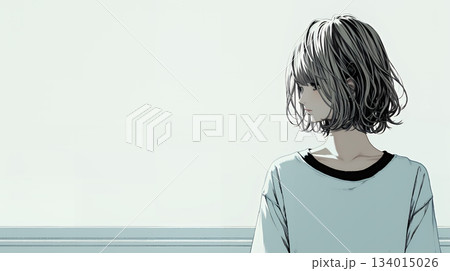 白い壁に向かって考え事をする若い女性