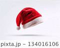 Festive red Christmas hat with white trim floating against a simple background showcasing holiday spirit and seasonal decorations 134016106