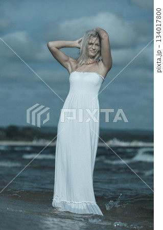 Young lady resting on beach. 134017800