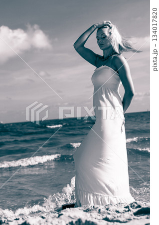 Beautiful woman on sunny beach. 134017820