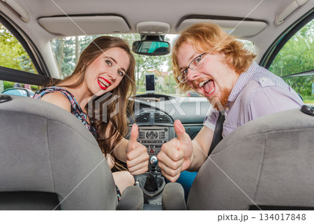 Happy man and woman in car 134017848