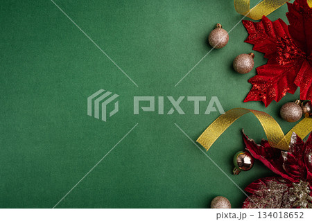 Red Poinsettias and Golden Ornaments on Green Background Red Poinsettias and Golden Ornaments on Green Background 134018652