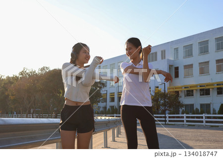 Two Asian Women Stretching Outdoor. 134018747
