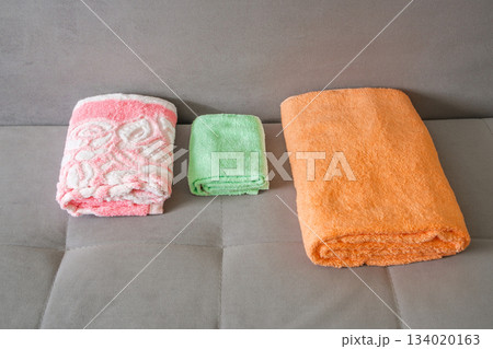 colorful folded towels on the couch colorful folded towels on the couch 134020163