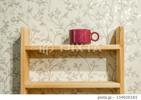 purple tea mug on wooden shelf 134020165
