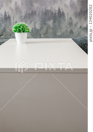 artificial flower in pot on white table 134020262