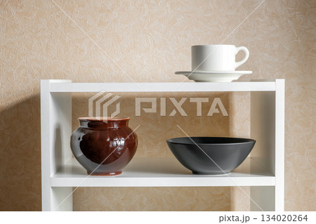 dishes cup pot bowl on white shelves 134020264