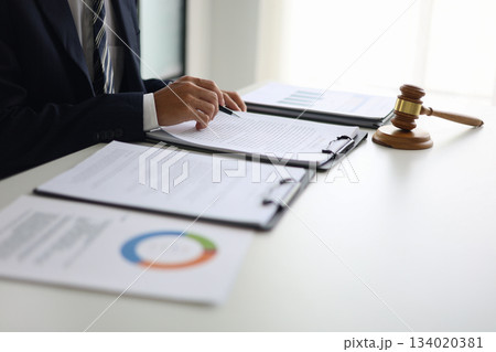 Legal counsel reading contract paperwork to finalize a legal agreement. Legal counsel reading contract paperwork to finalize a legal agreement. 134020381