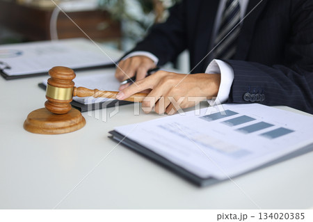 Legal counsel reading contract paperwork to finalize a legal agreement. Legal counsel reading contract paperwork to finalize a legal agreement. 134020385